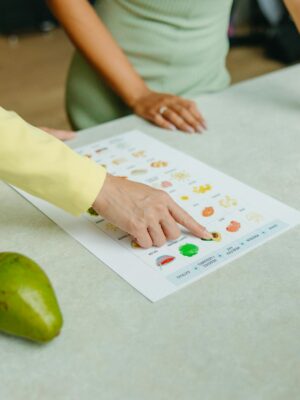 Two adults discussing food options with a chart, highlighting healthy nutrition indoors.