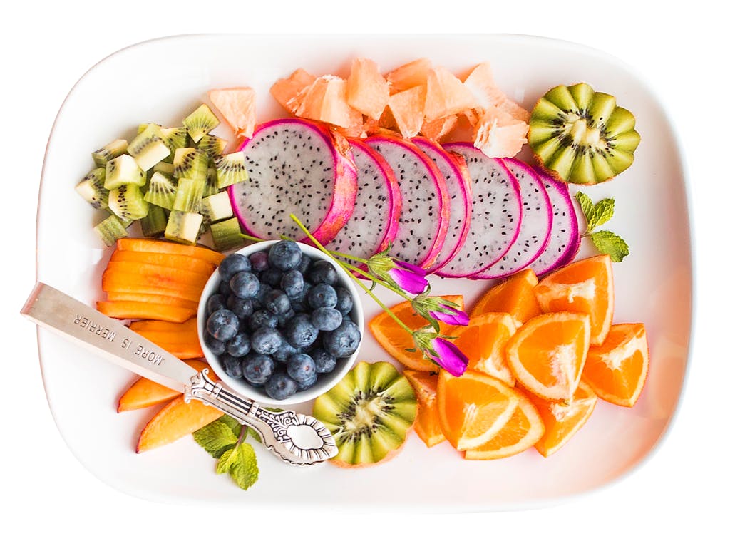Vibrant tropical fruit platter with dragon fruit and more, shot from above.